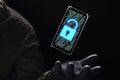 Close up illuminate unlock icon with green binary code on screen of smartphone floating above of hacker`s hand in black glove on Royalty Free Stock Photo