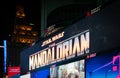 Close up on illuminated billboard at Times Square showing the New Disney plus series The Mandalorian.