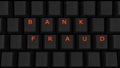 Close Up of Illuminated Glowing Keys on a Black Keyboard Spelling Bank Fraud