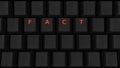 Close Up of Illuminated Glowing Keys on a Black Keyboard Spelling Fact