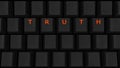 Close Up of Illuminated Glowing Keys on a Black Keyboard Spelling Truth