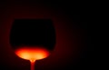 Close up of illuminated isolated red yellow glowing black cocktail glass