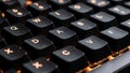 Black keycaps with orange backlighting highlight the letters and numbers Royalty Free Stock Photo