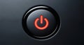 Close up of illuminated red power button glowing brightly on dark electronic device surface Royalty Free Stock Photo