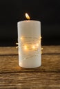 Close up of illuminated string lights wrapped on lit candle