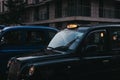 Close up of an illuminated taxi sign on a black cab in London, UK. Royalty Free Stock Photo