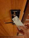 Image of analog punchcard as a key to open hotel room door Royalty Free Stock Photo