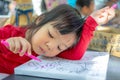 Close up image of asian little girl who is drawing with colorful pencils Royalty Free Stock Photo