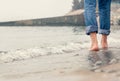Close up image barefoot man legs in the sea surf Royalty Free Stock Photo