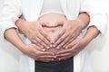 Pregnant woman and her handsome husband hugging the tummy in home Royalty Free Stock Photo