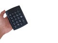 Close-up image of a black numeric keypad held by a man's hand.
