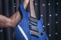 Close-up image of a blue electric guitar