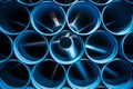 A close-up of blue plastic pipe rolls stacked on top. Royalty Free Stock Photo