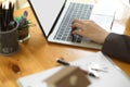 Business women`s hand typing on laptop keyboard. woman working from home Royalty Free Stock Photo