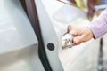 Close up image of a businessman hand on handle opening a car door. Royalty Free Stock Photo