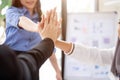 Close-up image of businesspeople are putting their hand together after the meeting