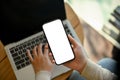 Close-up image A businesswoman remote working at the cafe, using her laptop and smartphone Royalty Free Stock Photo