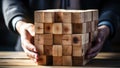 Close-up image of businesswoman\'s hands placing wooden cube on table