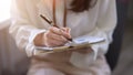 Close-up image, businesswoman signing her signature on a documents