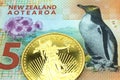 A New Zealand five dollar bill with a gold bar in macro