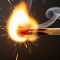 A close-up image captures a match igniting, with the red head producing bright Royalty Free Stock Photo
