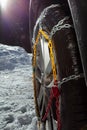 Close-up image of the car wheel with winter chains for icy road Royalty Free Stock Photo