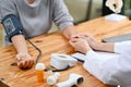Close-up image of a caring doctor holding a patient's hand while checking her blood pressure Royalty Free Stock Photo