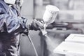 Close up image of carpenter painting with a paint spray gun Royalty Free Stock Photo