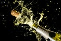 Close up image of champagne cork flying out of champagne bottle. Celebration theme with explosion of splashing champagne sparkling