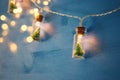 close up image of Christmas tree in the masson jar garland light over wooden blue background. Royalty Free Stock Photo