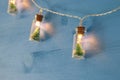 close up image of Christmas tree in the masson jar garland light over wooden blue background. Royalty Free Stock Photo