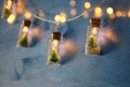 photo of Christmas tree in the masson jar garland lights over wooden blue background.