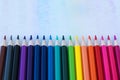 Close up image of colored pencils lie in a diagonal row like a rainbow. Royalty Free Stock Photo