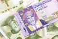 A colorful Omani riyal bank note on one dollar bills Royalty Free Stock Photo