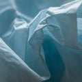 Close-up image of crumpled blue paper with a textured surface. The folds create Royalty Free Stock Photo