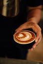 Close-up image of a cup of freshly brewed coffee with intricate latte art poured on top Royalty Free Stock Photo