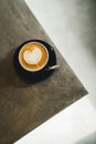 Close-up image of a cup of freshly brewed coffee with intricate latte art poured on top Royalty Free Stock Photo