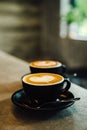 Close-up image of a cup of freshly brewed coffee with intricate latte art poured on top Royalty Free Stock Photo