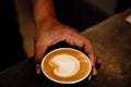 Close-up image of a cup of freshly brewed coffee with intricate latte art poured on top Royalty Free Stock Photo