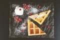 Close-up image of a delicious breakfast dish featuring freshly-baked waffles with berries