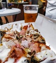 Close-up image of delicious pizza in takeout box and a plastic cup of beer Royalty Free Stock Photo