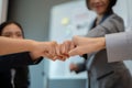 Close-up image of diverse businesspeople are giving fist bump in the meeting. team building Royalty Free Stock Photo