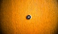 Close up image of a door peephole.