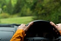 Close up image of Driver`s hands on steering wheel driving a modern off road right hand drive RHD car on the mountain green fores Royalty Free Stock Photo