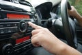 Driver& x27;s Hand Press Button on Car Radio