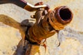 Close up image of a drop of water dripping from a rusty tap Royalty Free Stock Photo