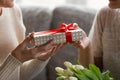 Close up image elderly womans hands holding present. Royalty Free Stock Photo