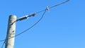 Close up image of electrical power pole cables with clear sky background