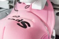 Close up picture of pink cap and embroidery machine