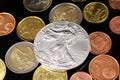 A close up image of Euro coins with a silver American coin on a black background Royalty Free Stock Photo